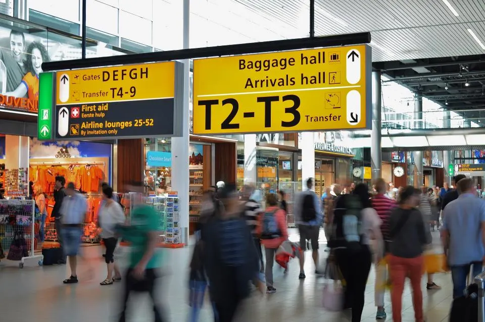 A busy airport arrivals hall