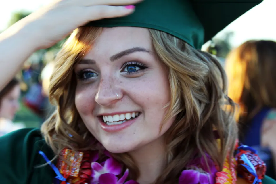 A graduate smiling in her cap